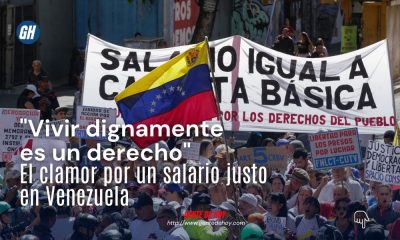 Manifestantes sostienen pancartas durante la jornada de protesta en Caracas, exigiendo que el salario mínimo cubra la canasta básica y respete los derechos constitucionales.